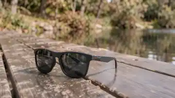 Polarisierte Sonnenbrille auf spiegelnder nasser Fläche